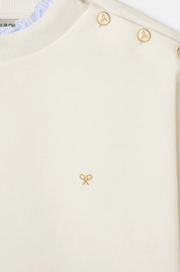 Detalle sudadera cruda Silbon mujer con botones dorados y logo